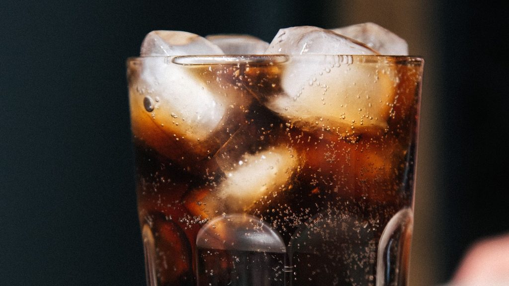 氷の入ったコップにコーラが入っている